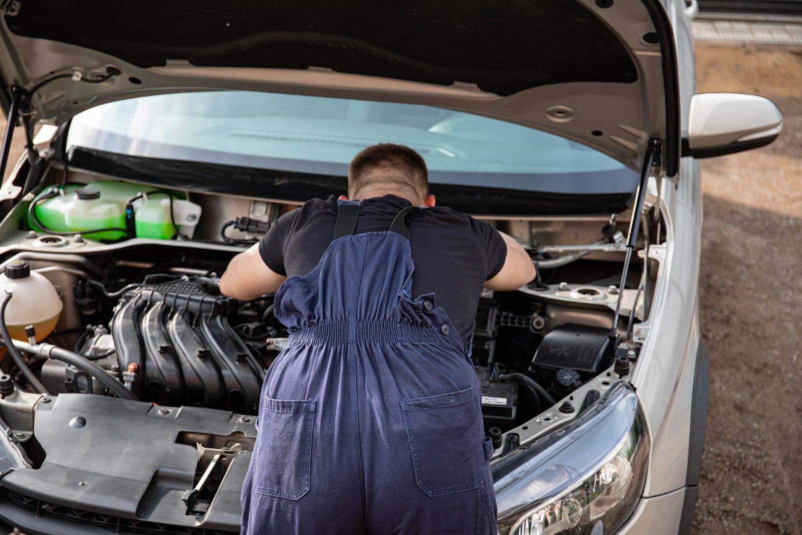 Mechanic performing automotive engine repairs