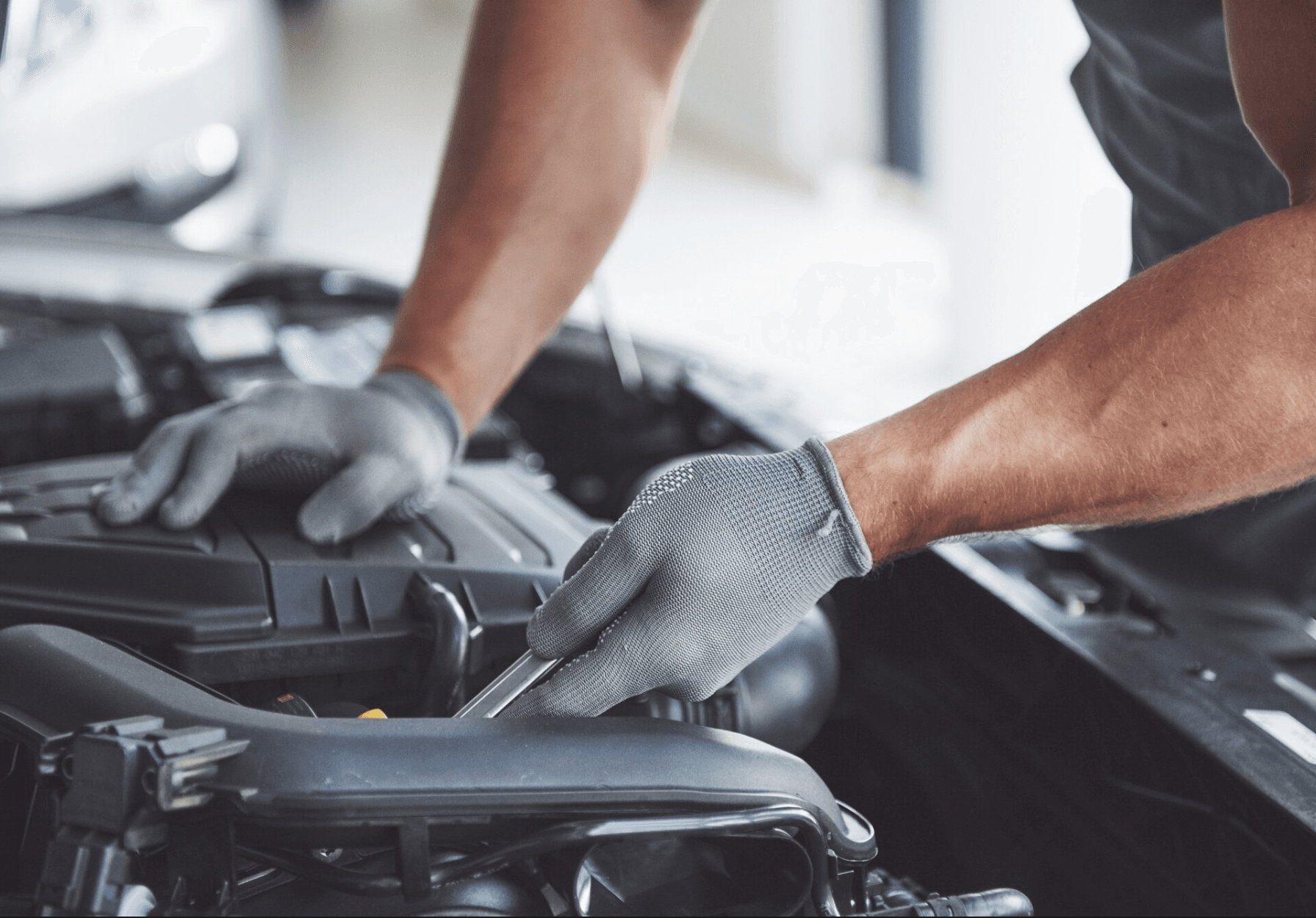 Technician working on a vehicle engine